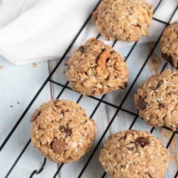 healthy vegan oatmeal cookies lined up on a cooling rack