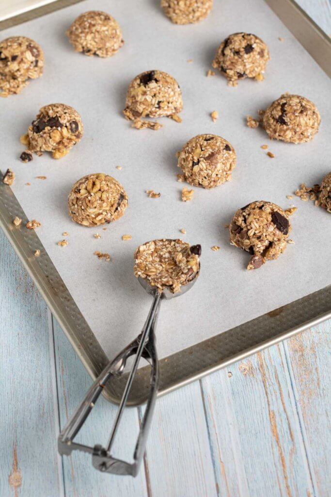 using a cookie scoop to shape and size oatmeal cookies
