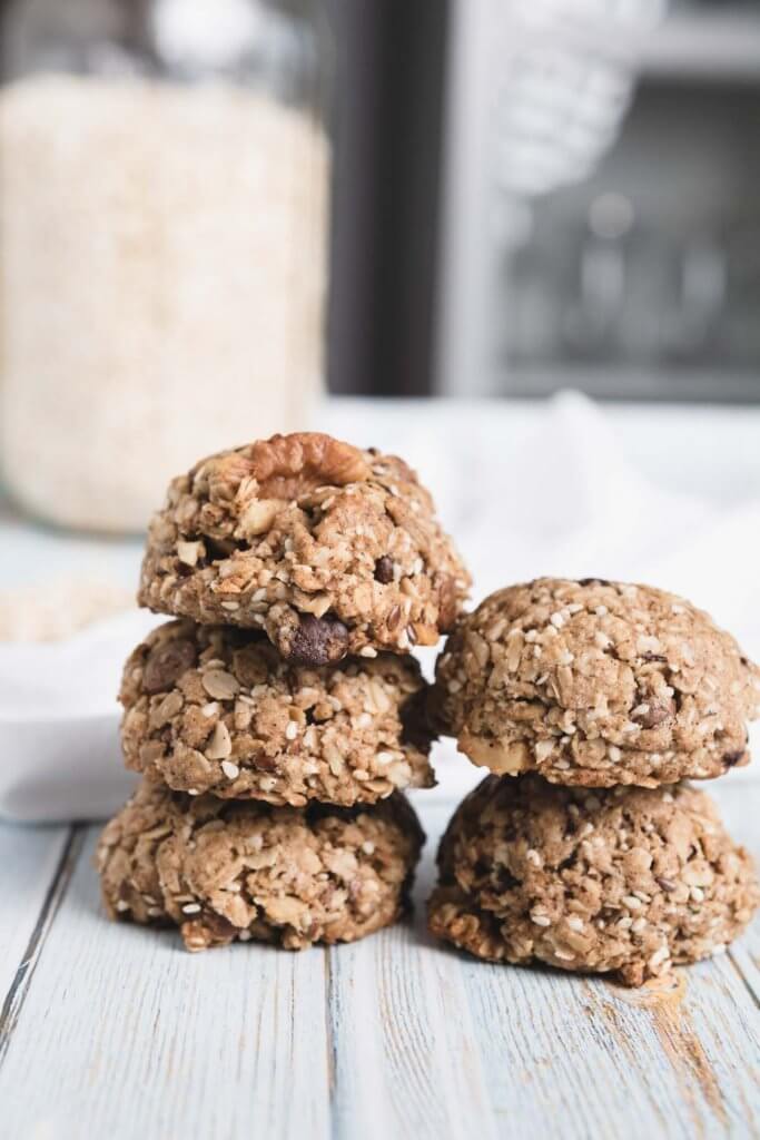 stacks of healthy vegan oatmeal cookies with  oats behind