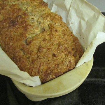 fresh baked apple flaxseed bread in stone baking dish