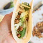 taco filled with chickpeas, slaw and vegan queso