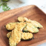 grilled jalapeno poppers ona wooden plater with cilantro