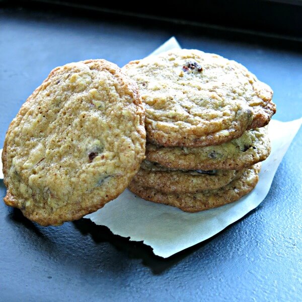 Chocolate Chip Hazelnut Cookies stacked on a piece of parchment paper