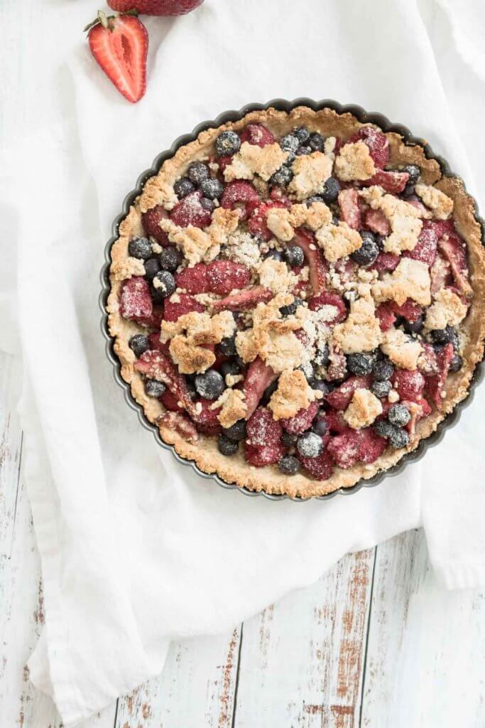 mixed berry crumble pie in a tart pan