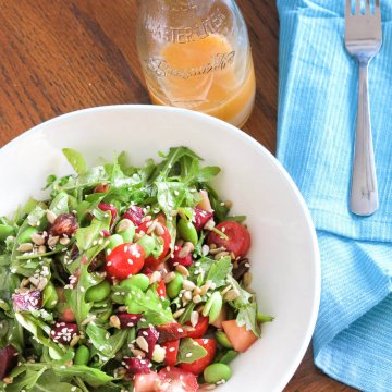 arugula, edamame, beet and date salad with jar of grapefruit viniagrette