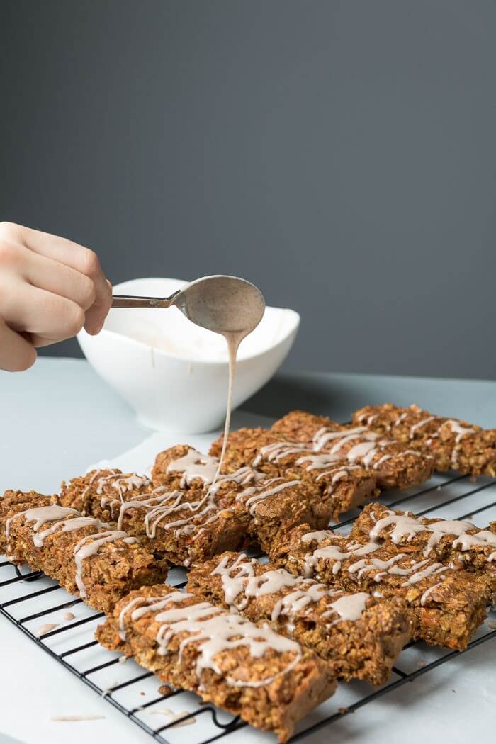 Carrot Cake Breakfast Bars with cinnamon frosting drizzled on