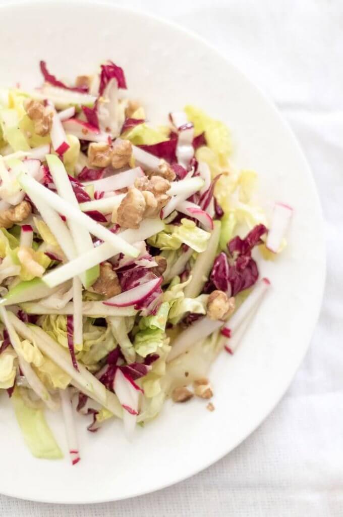 winter salad with apple and radicchio on a white plate