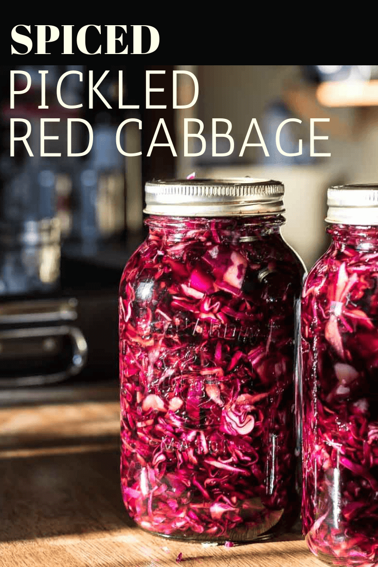 two jars of pickled red cabbage on a kitchen counter