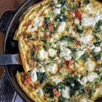 spinanch and goat cheese frittata in a skillet