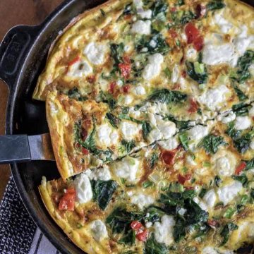 spinanch and goat cheese frittata in a skillet