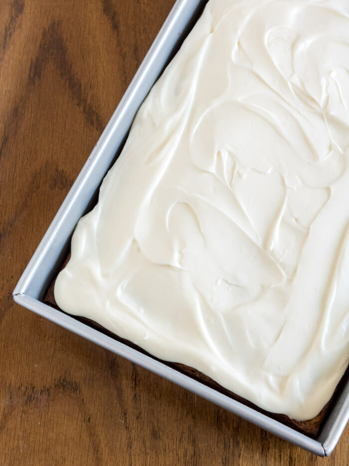 perfectly frosted pineapple carrot cake in a cake pan