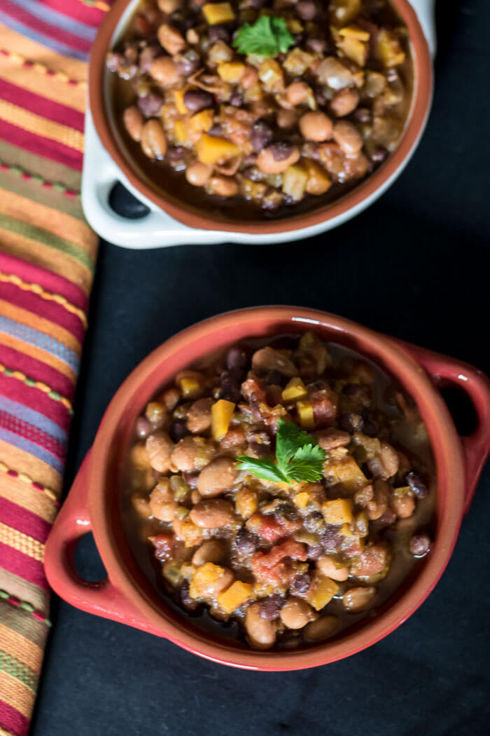 Vegan Butternut Chili in two bowls with colourful napkin