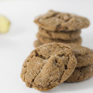 a stack of ginger molasses cookies with fresh ginger