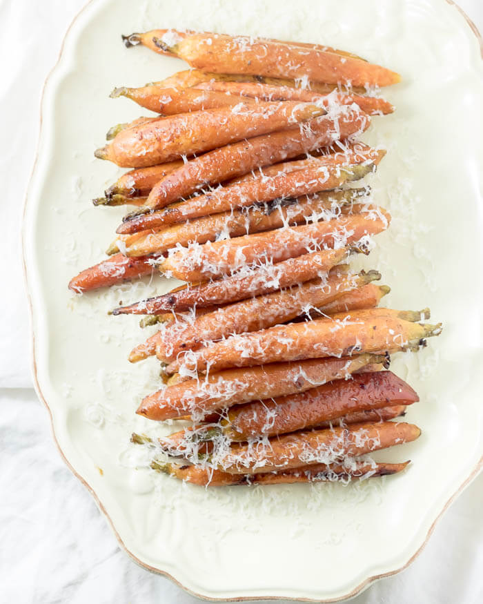 Balsamic Roasted Carrots sprinkled with parmesan on a platter