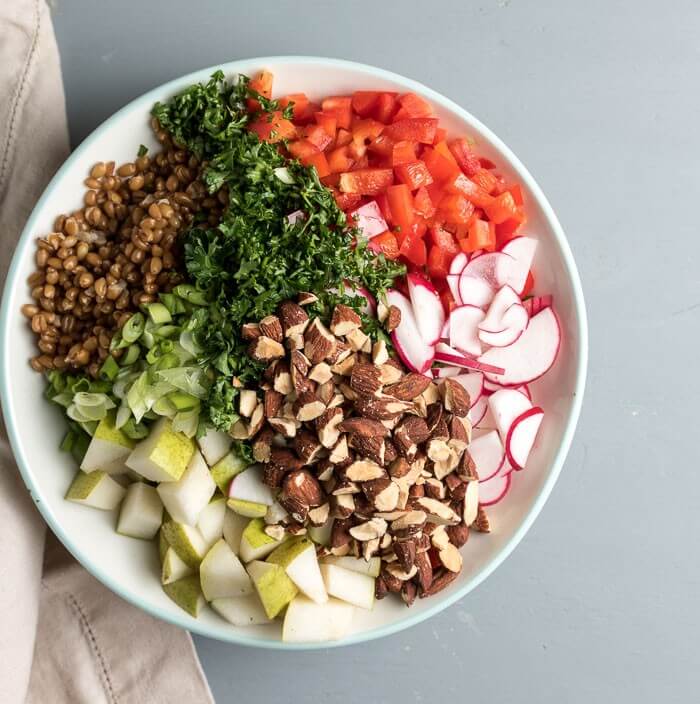 wheat berry lunch bowl, with almonds, pears, radish and parsley