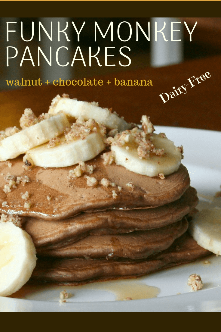 a stack of chocolate pancakes topped with banana and walnuts