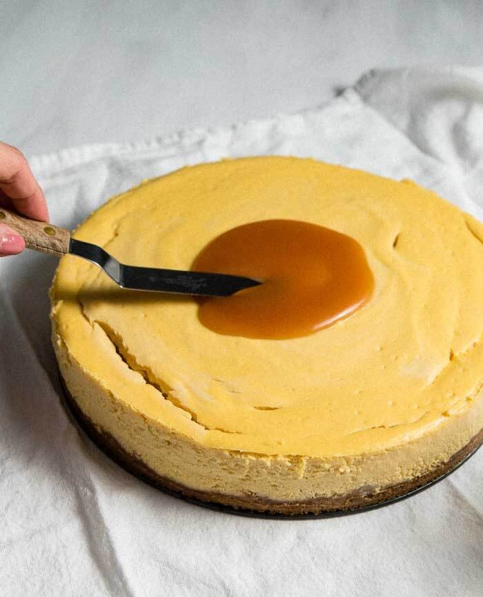 Spreading caramel on banana cheesecake