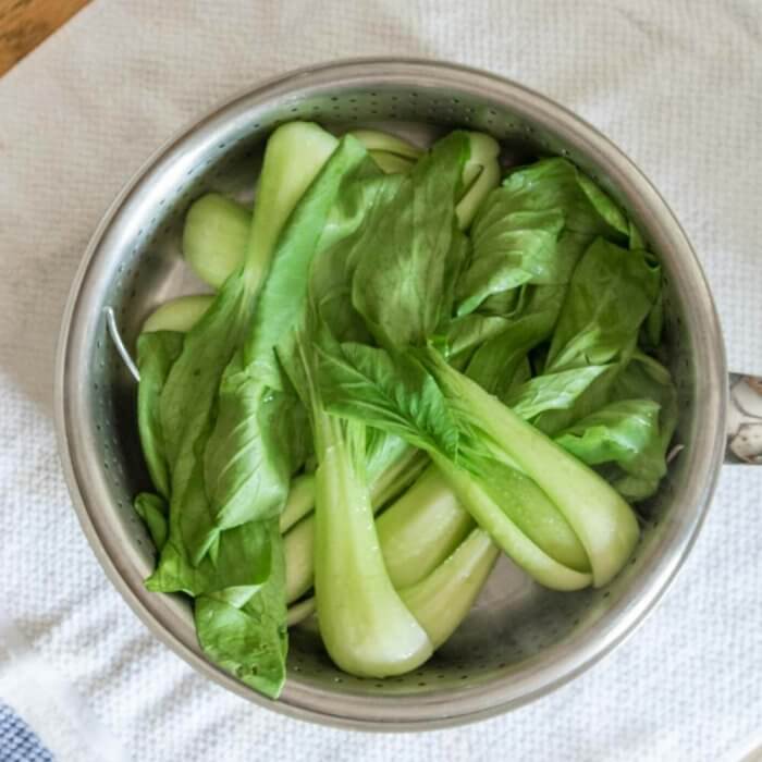 baby bok choy in a steamer basket