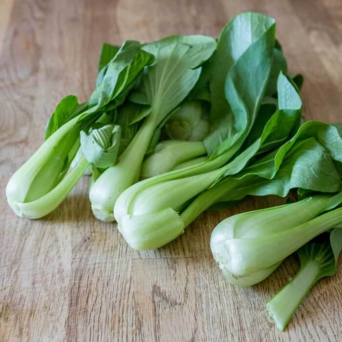 baby bok choy on a cutting board