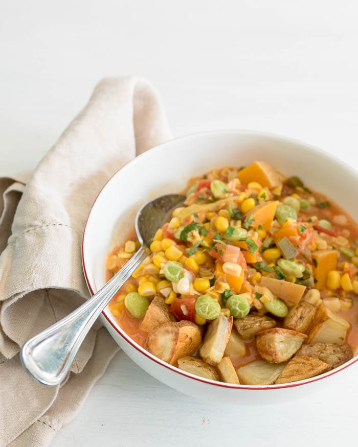 a bowl of summer succotash with roasted potatoes