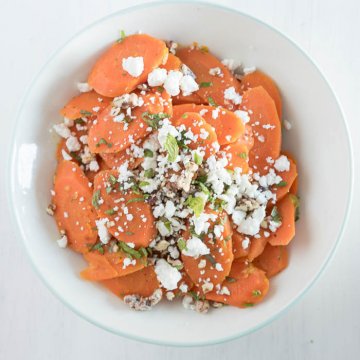 glazed carrots with feta and pecans in serving bowl