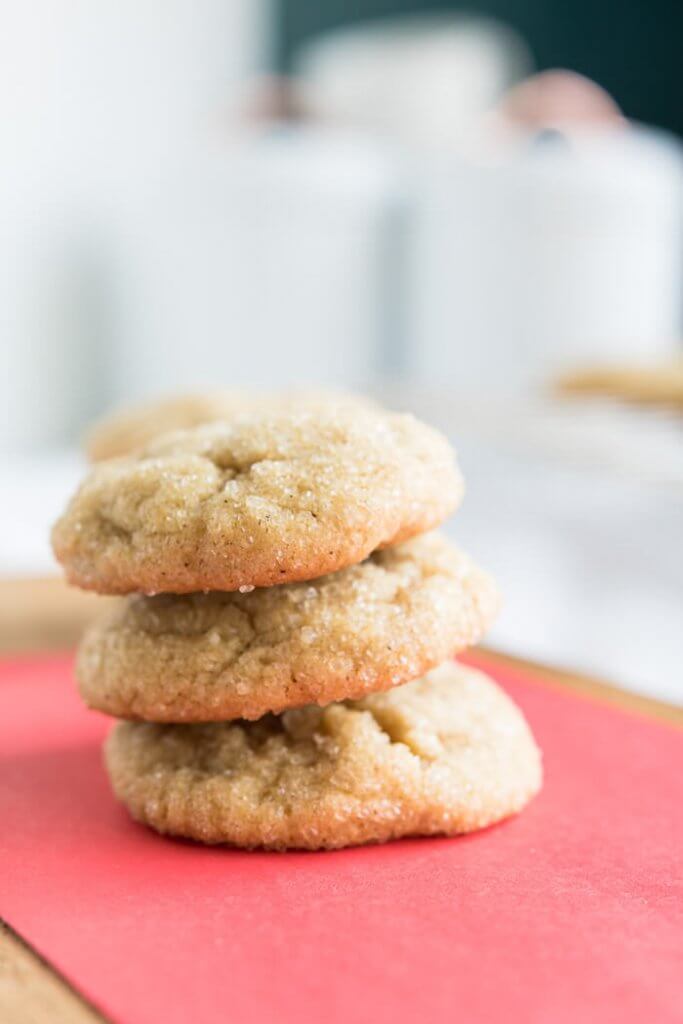 a stack of chewy almond flour brown sugar cookies on a red table top