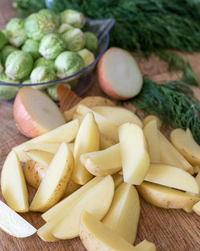 sliced potatoes and Brussel sprouts for sheet pan meal