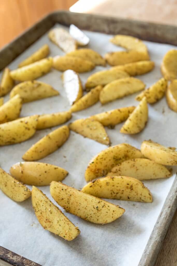 potato wedges roasted on a sheet pan