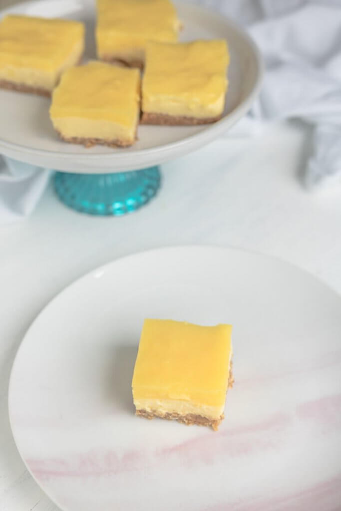 lemon cheesecake squares on a serving plater