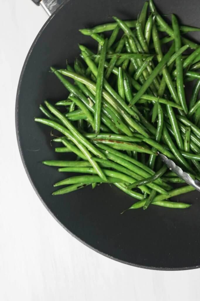 prefectly stir-fried green beans are tender crisp and slightly charred