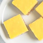 lemon cheesecake squares on a white plate