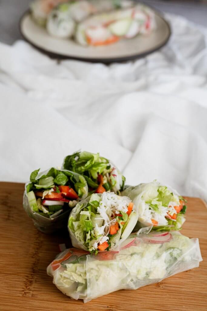 vegetable salad wraps filled with rice noodles, lettuce, fresh crunchy vegetables on a plater