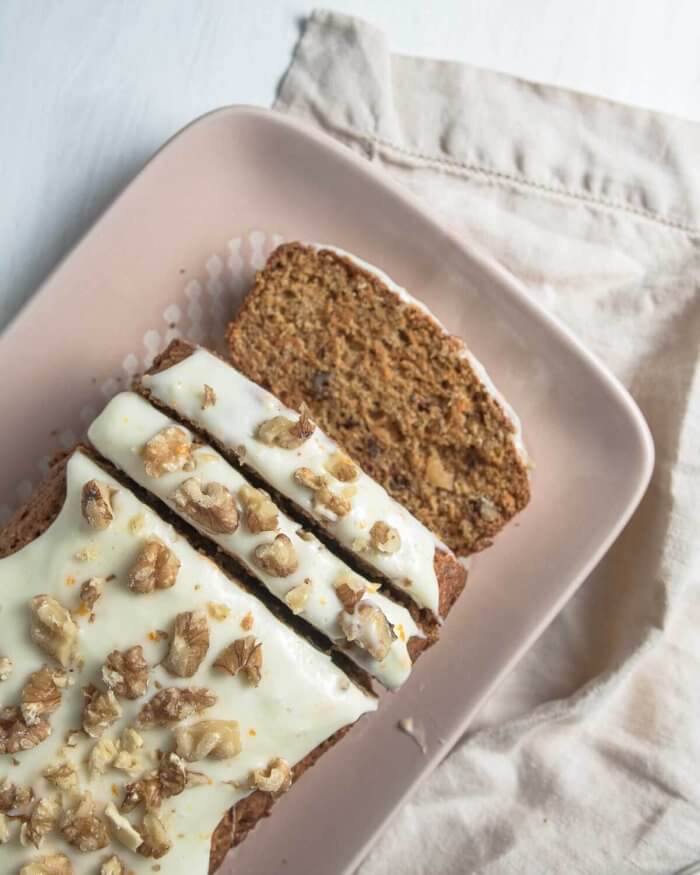 carrot loaf cake with walnuts, sliced on a platter