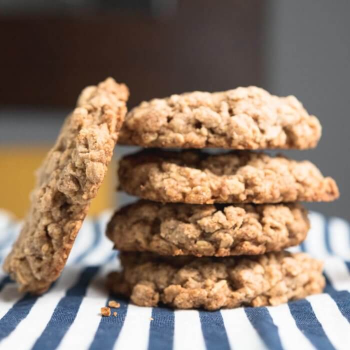 a stack of granola cookies on a blue and white table cloth