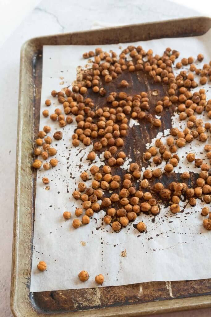 no-oil taco spiced roasted chickpeas on a baking sheet with parchment paper