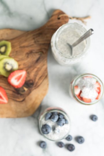 assembling chia seed pudding parfaits with berries