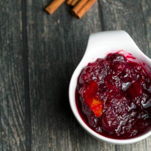 cranberry rum sauce in a white serving dish with cinnamon
