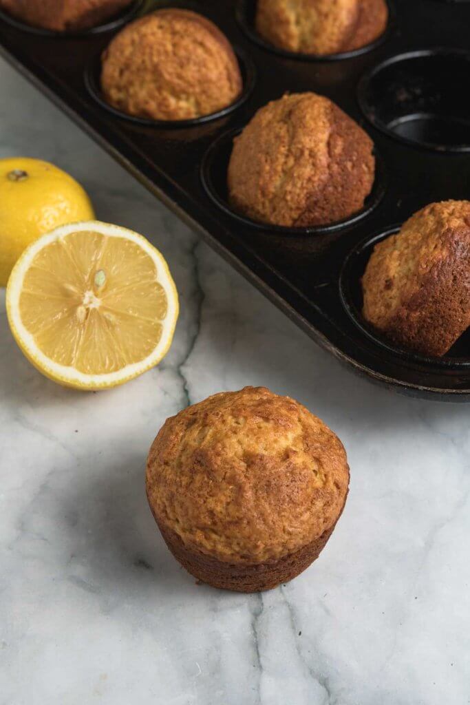 lemon muffins with cut lemons in background