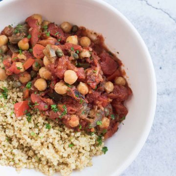 eggplant stew with chickpeas served in a bowl with quinoa