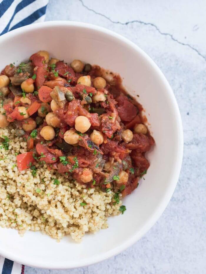 eggplant stew with chickpeas served in a bowl with quinoa