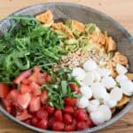 tortellini pasta salad with pesto, arugula and bocconcini cheese ready for tossting