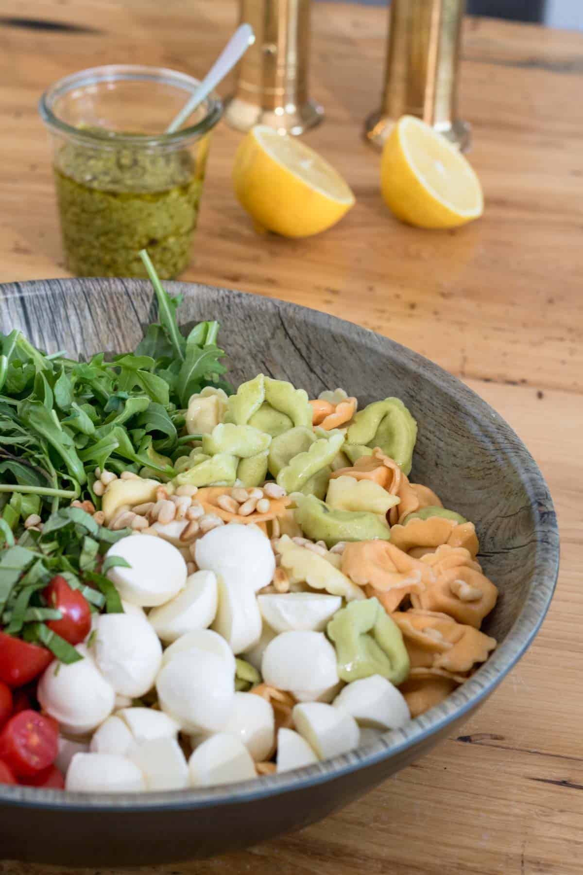 tortellini pasta salad with peso, arugula, bocconcini cheese and tomatoes. Add lemon when tossing to brighten the flavours