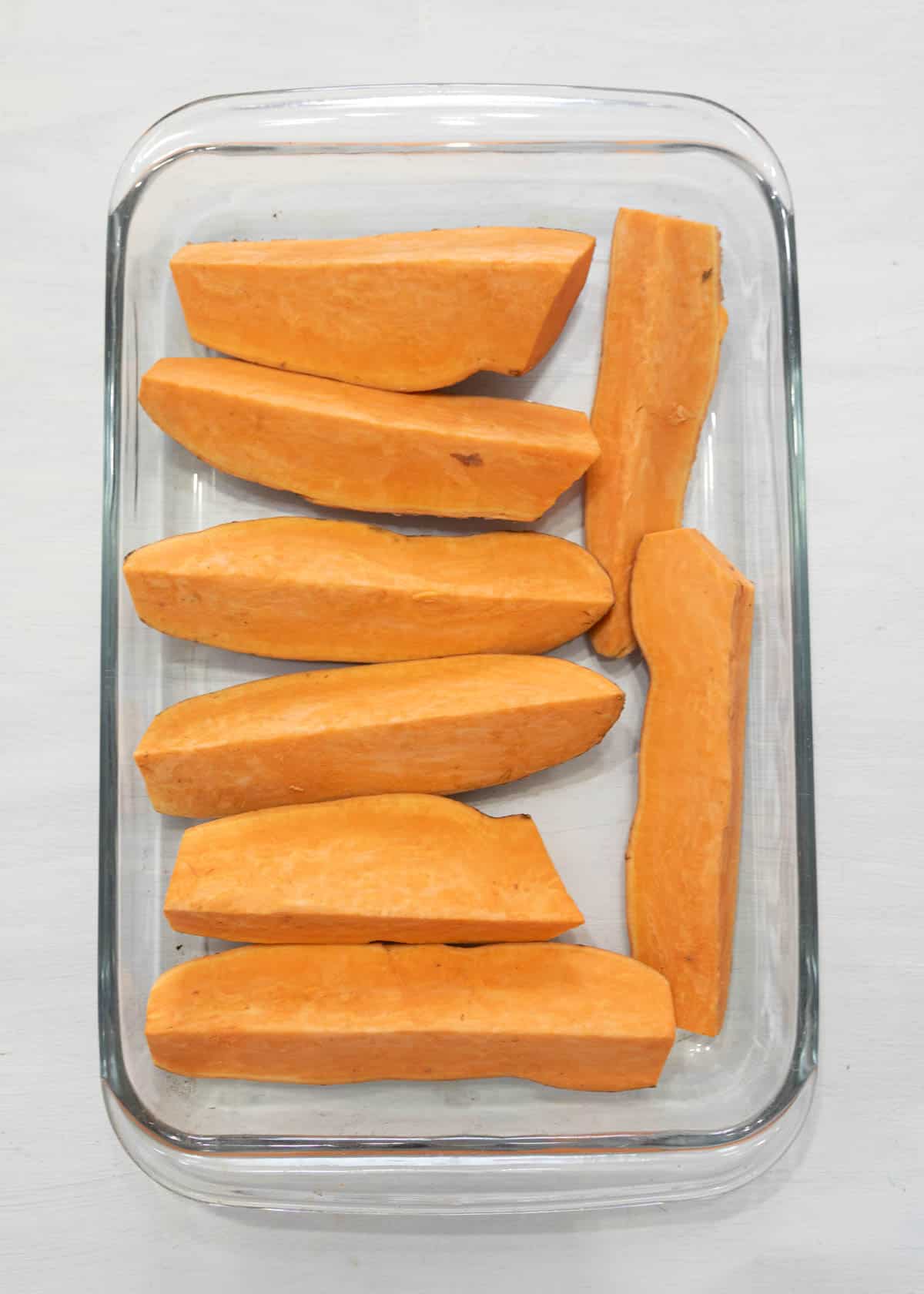 wedges of raw sweet poatoes ready for baking