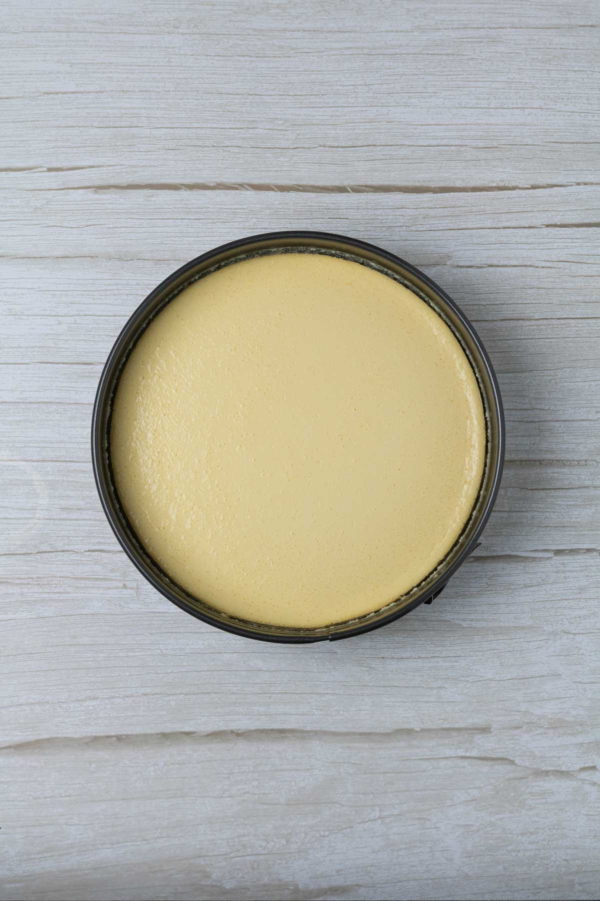 almond cheesecake after baking, perfectly smooth cake no cracks