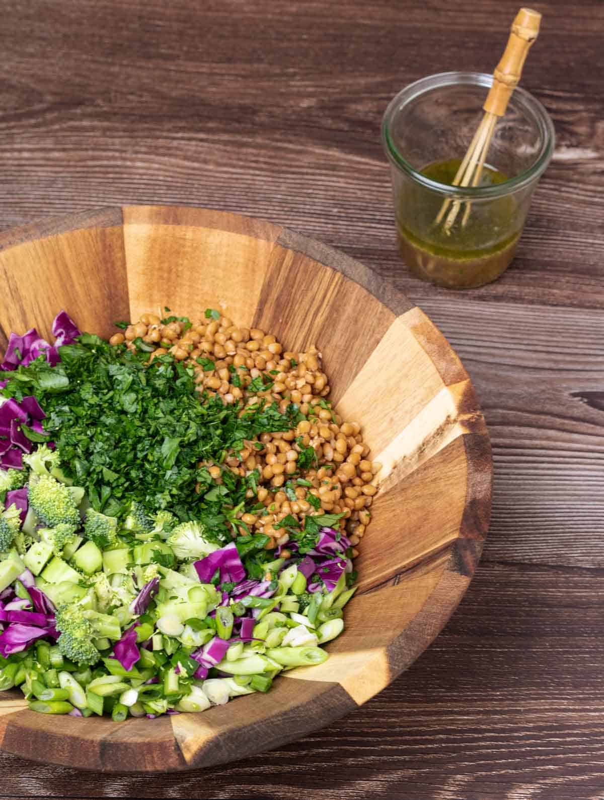 chopped broccoli, red cabbage and lentils in a large salad bowl