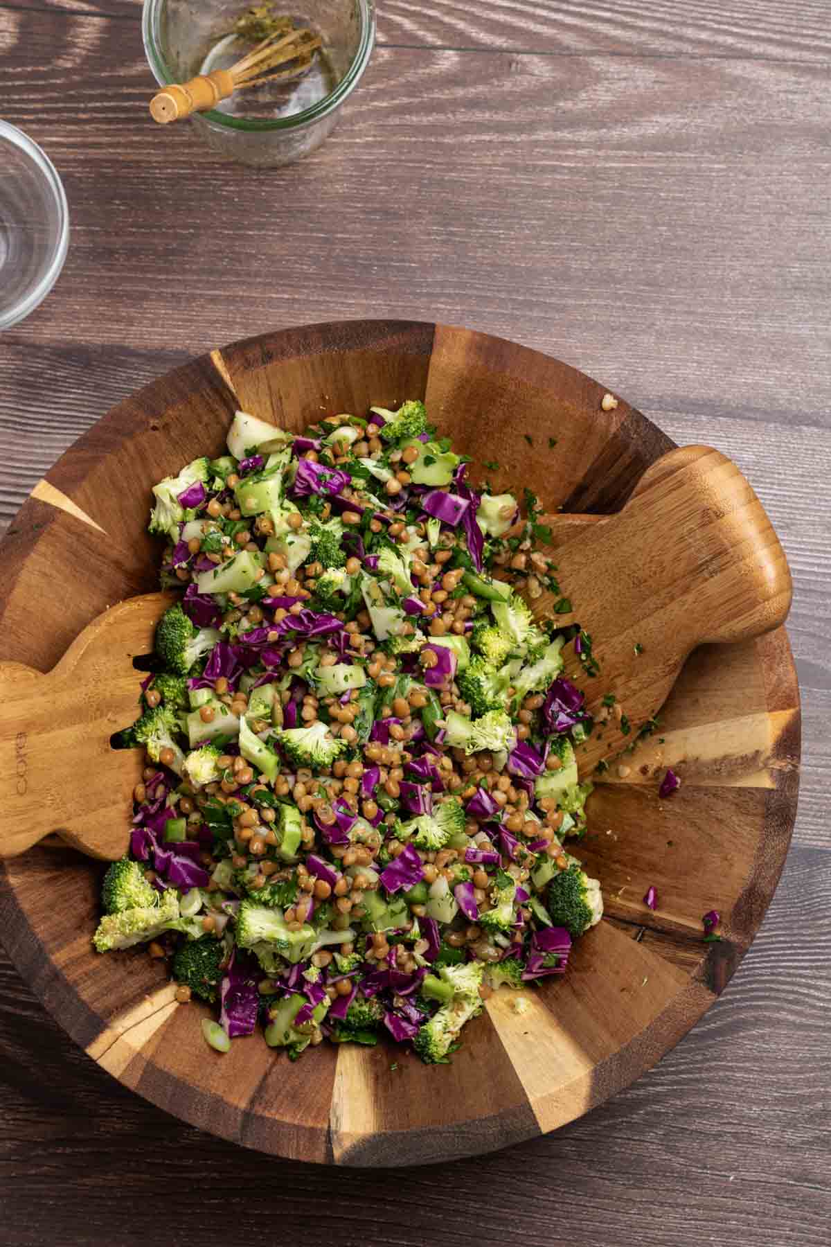 chopped broccoli salad with red cabbage and lentils in a wooden salad bowl