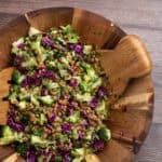 chopped broccoli salad with red cabbage and lentils in a wooden salad bowl