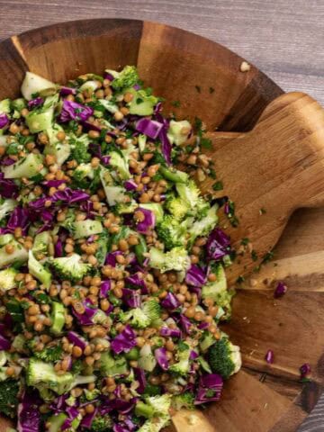 chopped broccoli salad with red cabbage and lentils in a wooden salad bowl